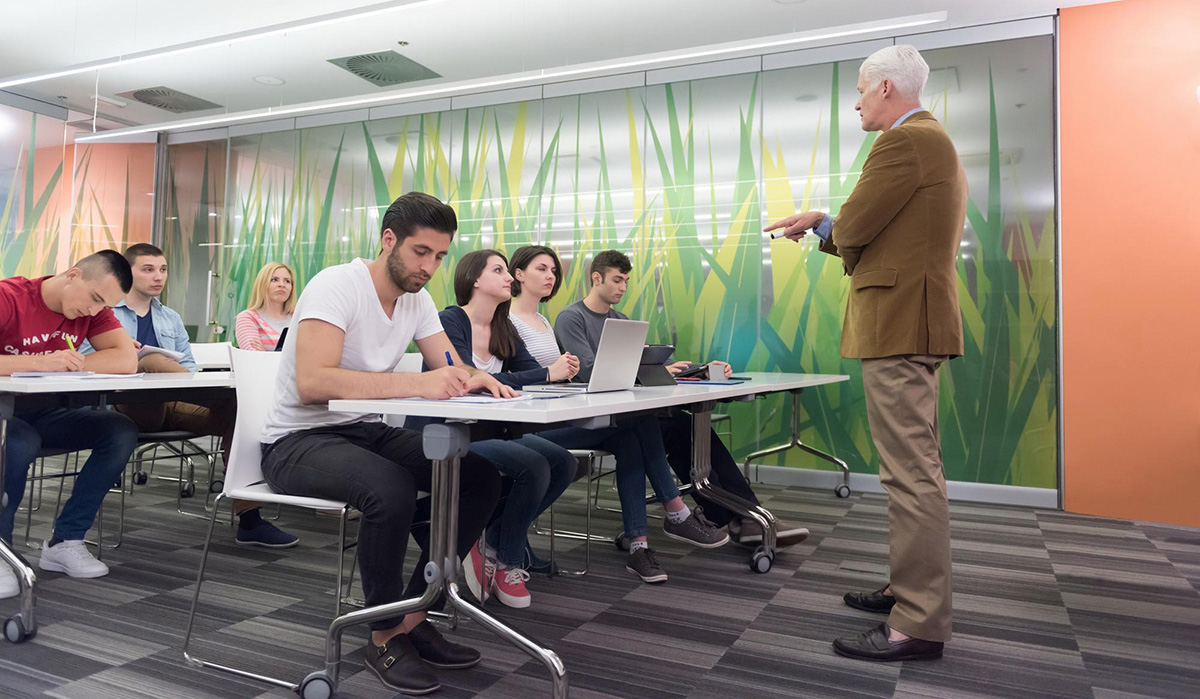 Teachers helping autistic students